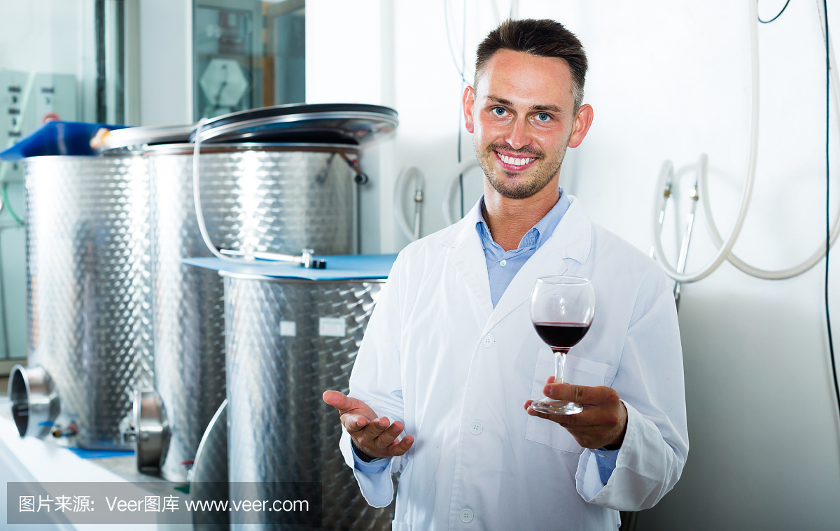 快樂的釀酒廠工人拿著酒杯